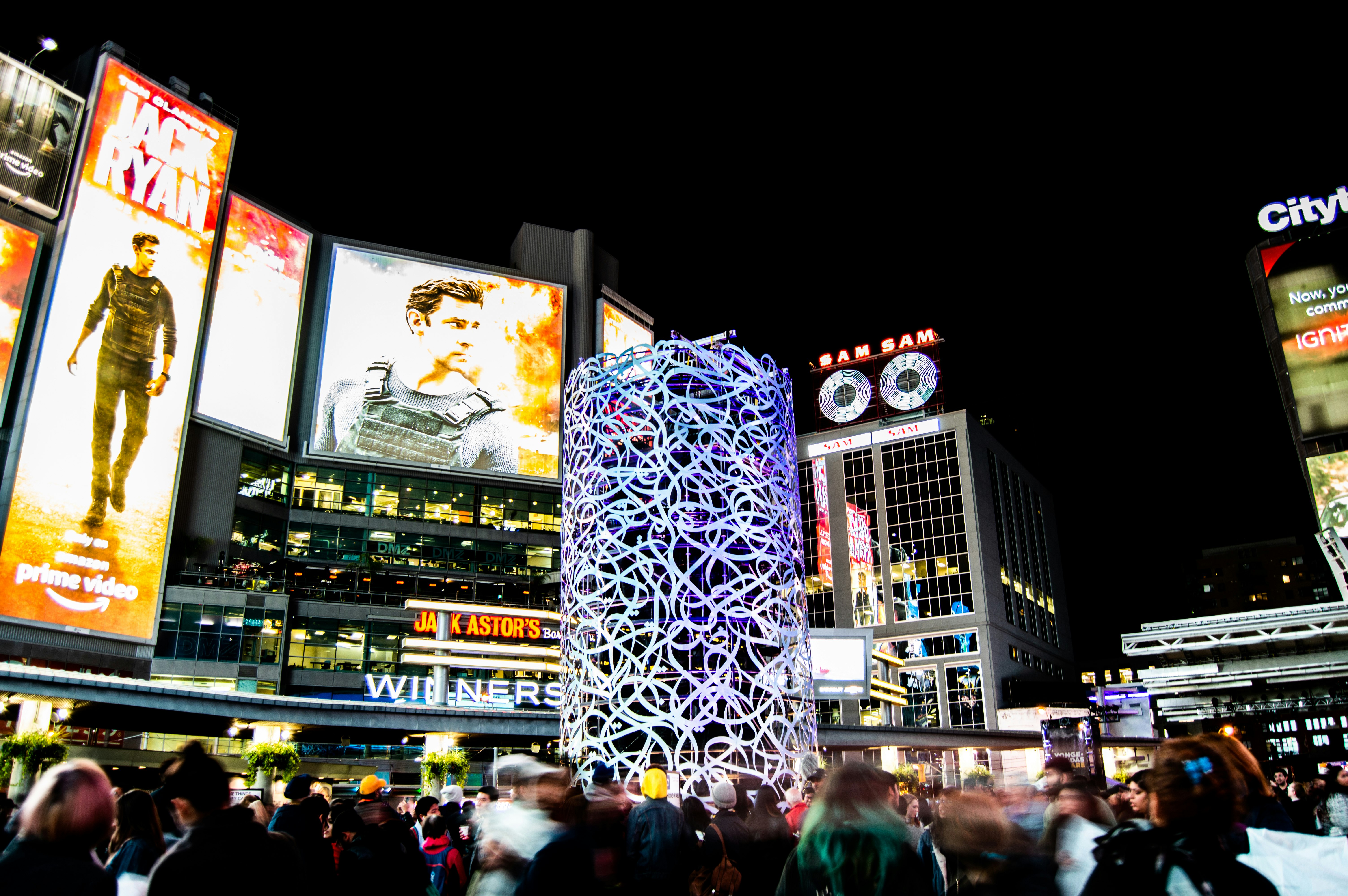 people near buildings during nighttime